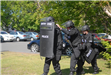 A team of police officers in riot gear.