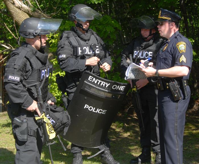 Police officers standing together talking.